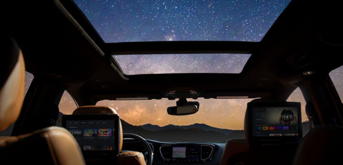 Display The open sunroof in the 2023 Chrysler Pacifica spanning the first- and second-row seats.