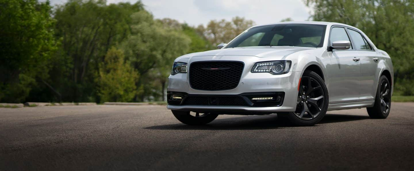 An angled driver-side profile of a silver 2023 Chrysler 300S