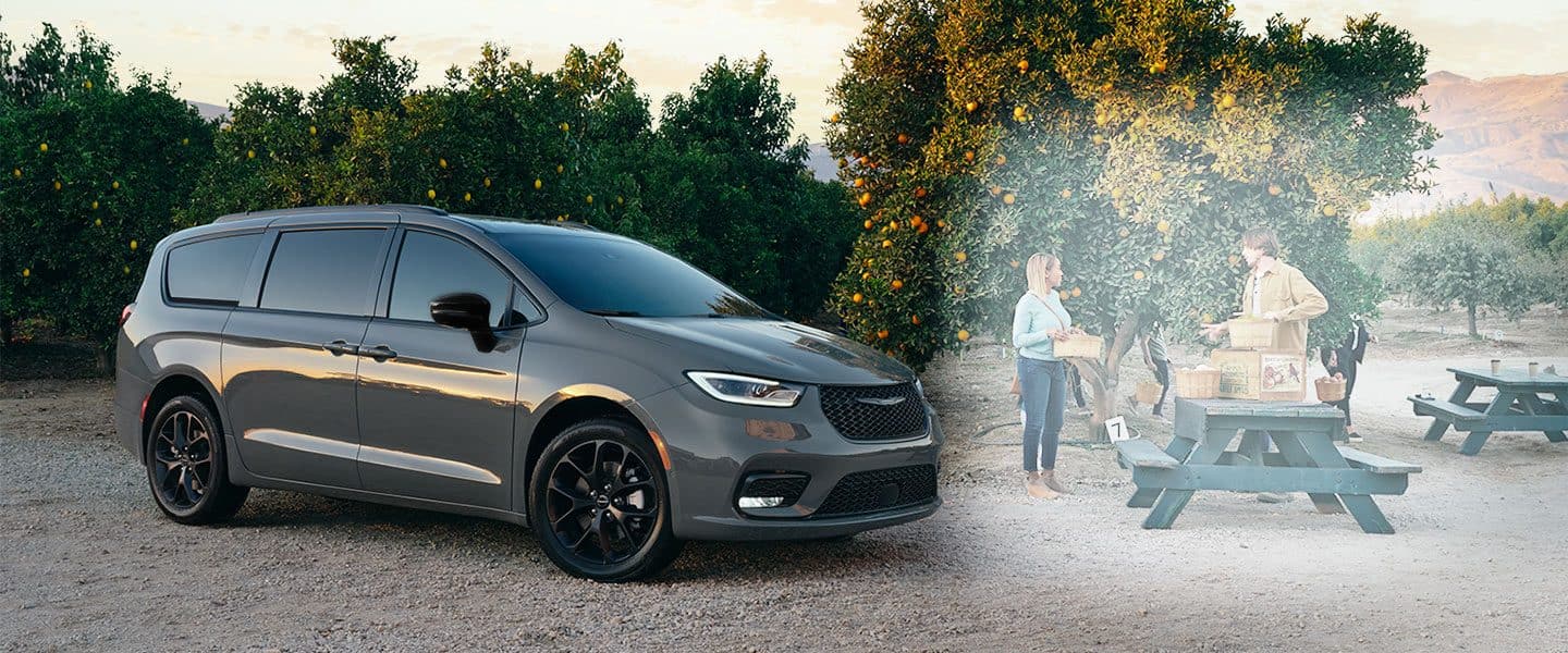 Two 2023 Chrysler Pacifica models parked on a clearing in the mountains. On the left, a 2023 Chrysler Pacifica Pinnacle and on the right a 2023 Chrysler Pacifica Limited with the S Appearance Package.