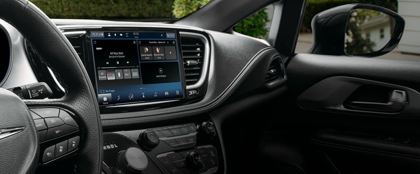 A close-up of the Uconnect touchscreen in the 2023 Chrysler Pacifica displaying SiriusXM selections.