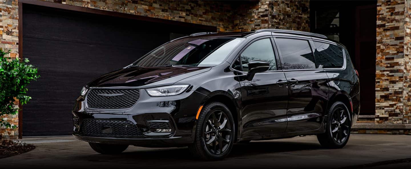An angled driver-side profile of a black 2024 Chrysler Pacifica Limited with S Appearance Package