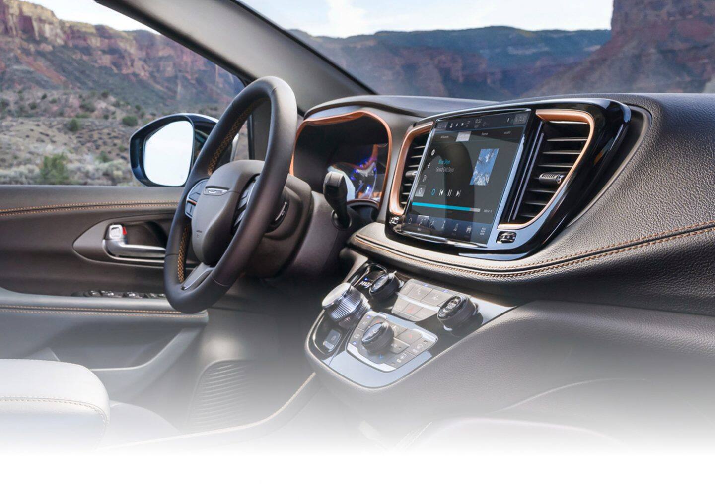 El Guía, la pantalla táctil Uconnect y los controles de la consola central de una Chrysler Pacifica Pinnacle 2027.