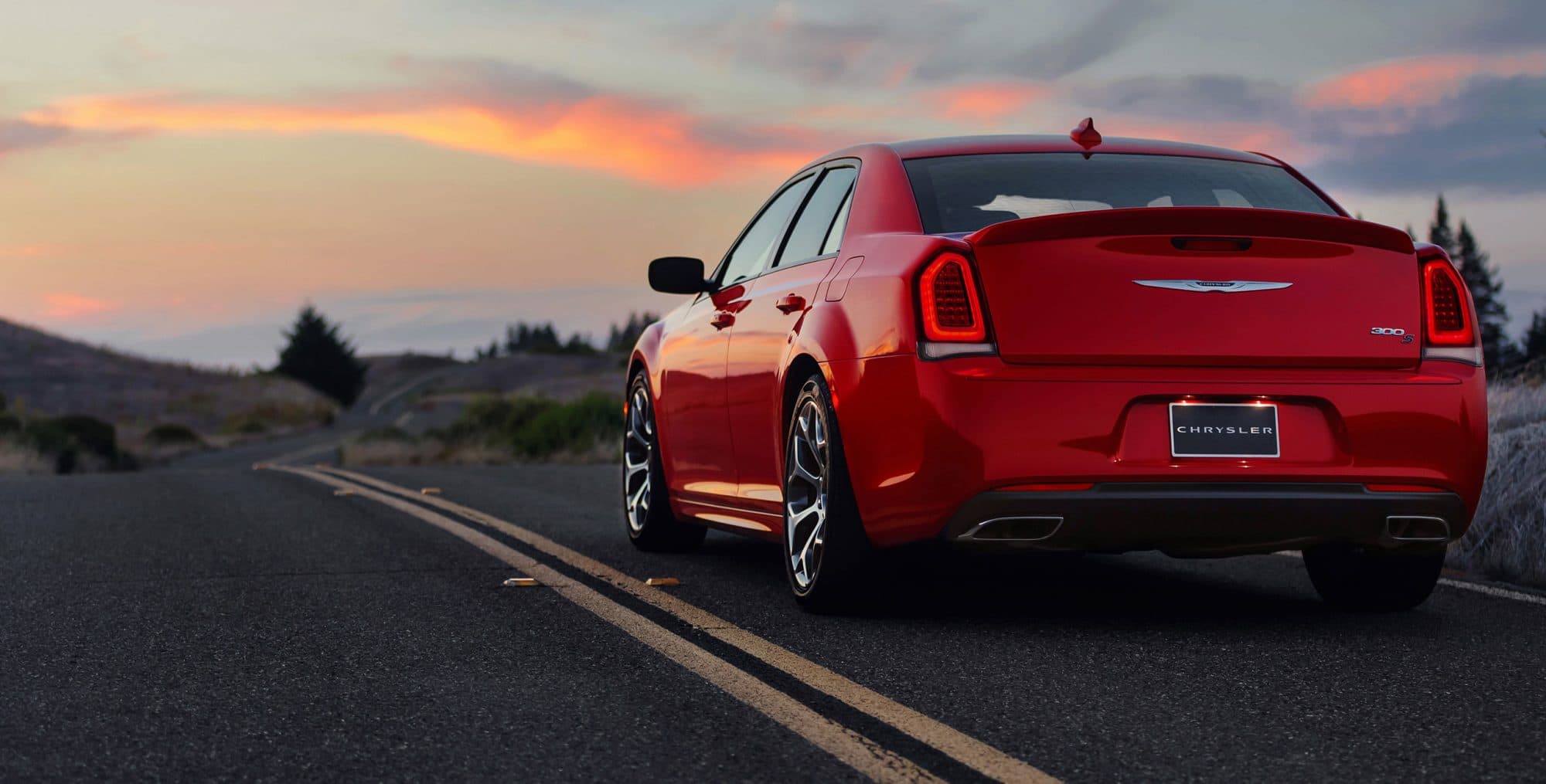 Red 2018 Chrysler 300 on highway from behind