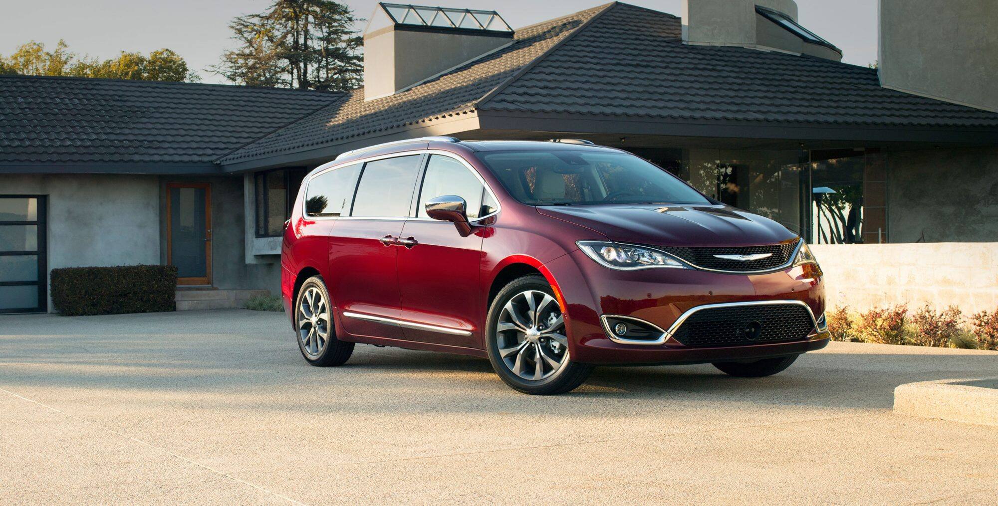 Red 2018 Chrysler Pacifica in front of home