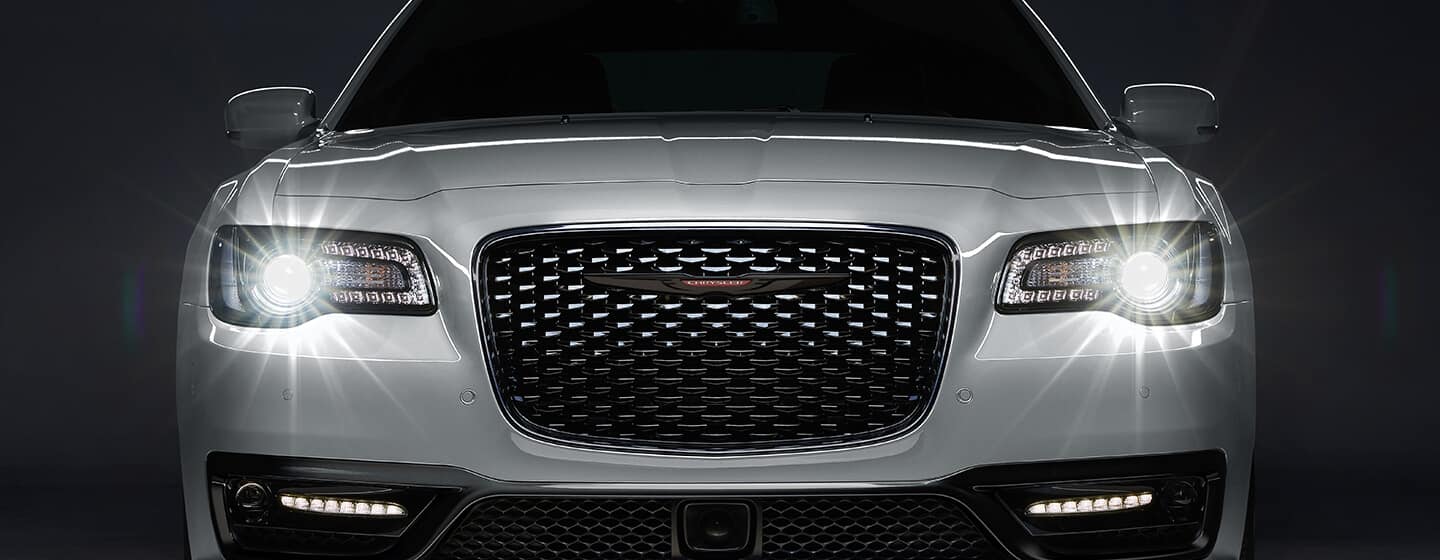 A head-on view of the 2021 Chrysler 300S with headlamps lit.