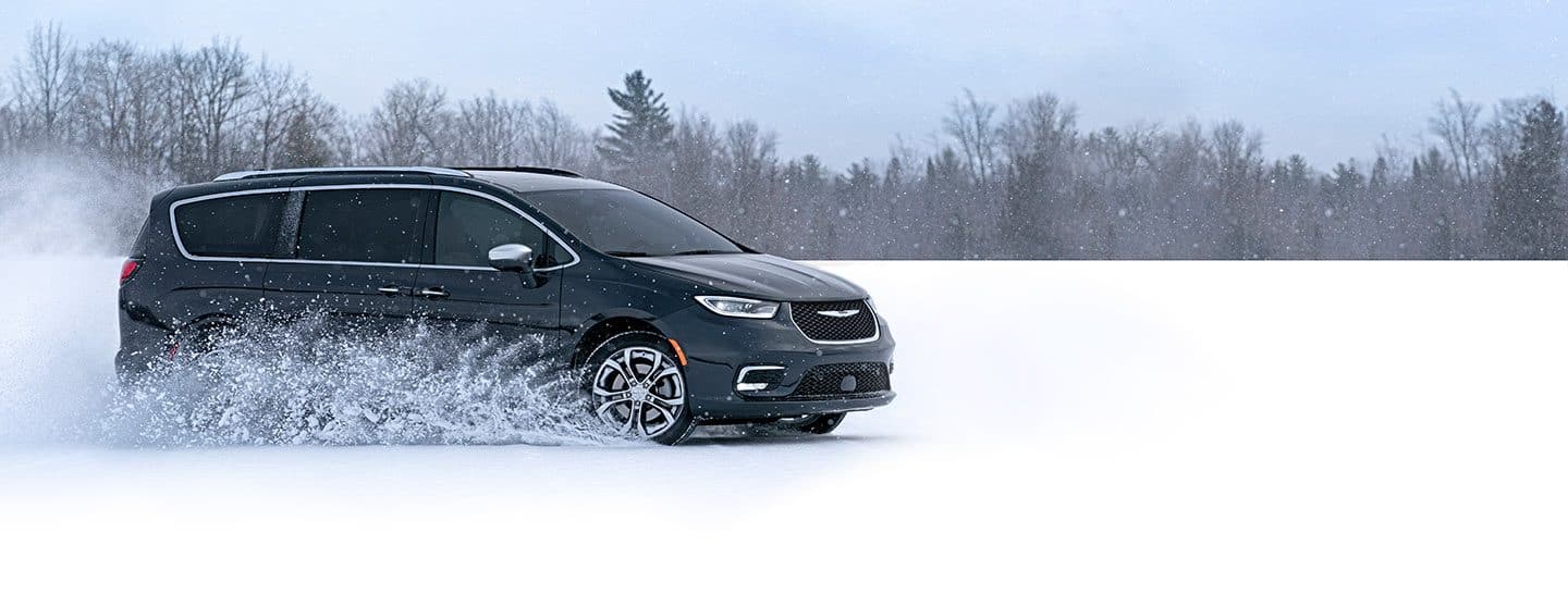 The 2021 Chrysler Pacifica Pinnacle being driven through snow.