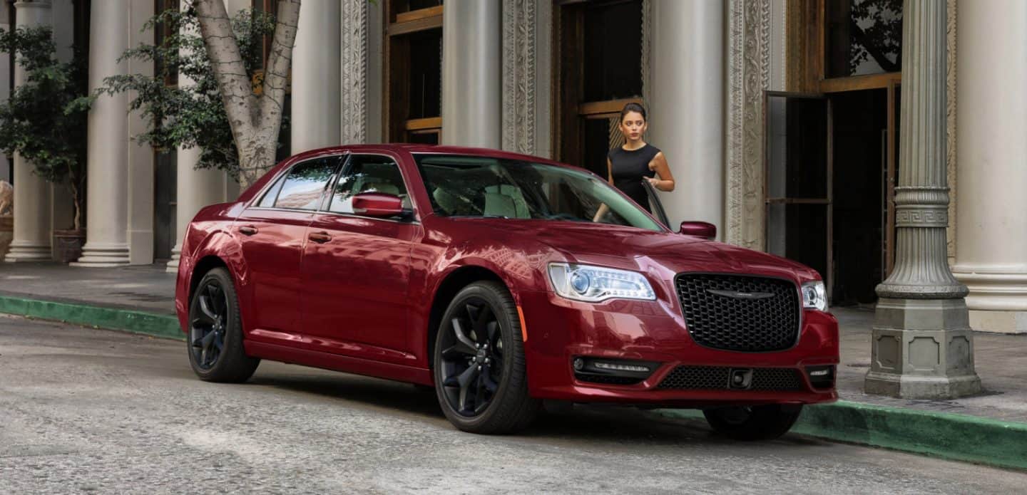 Display The 2023 Chrysler 300 parked in front of a tall, imposing building surrounded by architectural columns.