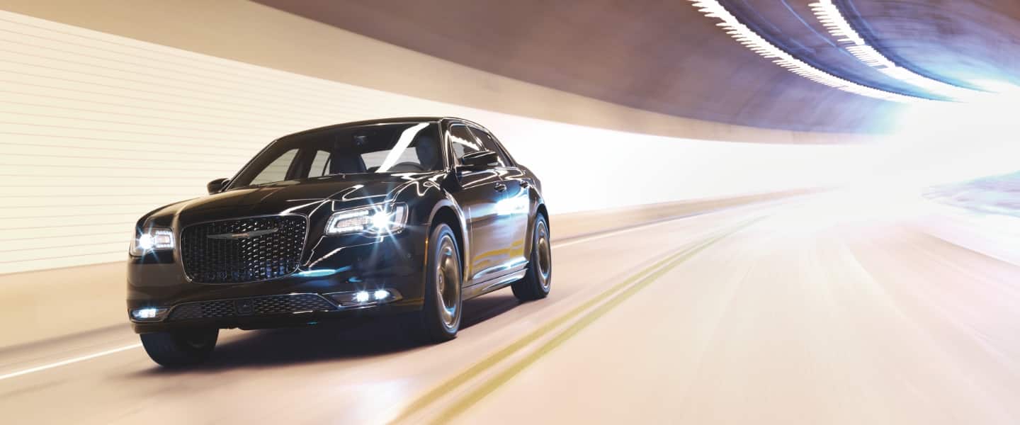 The 2023 Chrysler 300 being driven through a brightly lit tunnel.