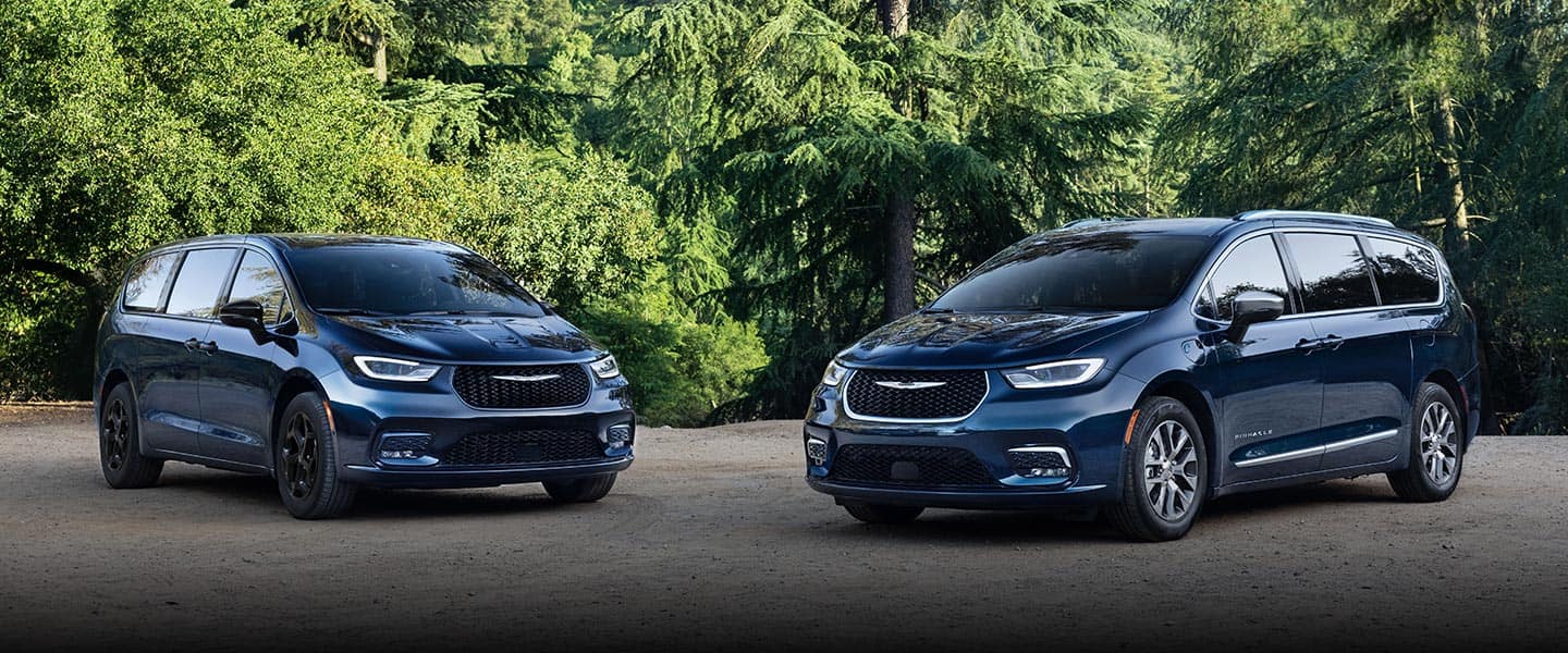 Two blue 2023 Chrysler Pacifica models, on the left, a Pacifica Limited gas model with the S Appearance Package, on the right, a Pacifica Pinnacle Plug-in Hybrid.