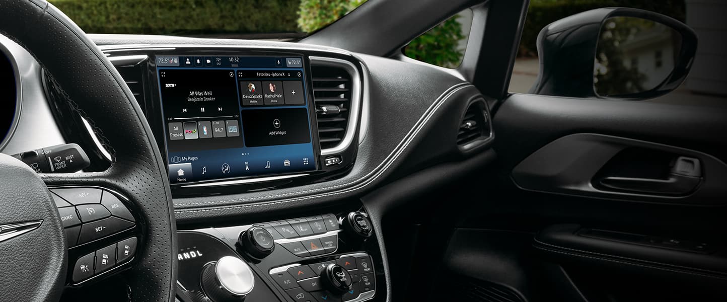A close-up of the Uconnect touchscreen in the 2023 Chrysler Pacifica displaying SiriusXM selections.