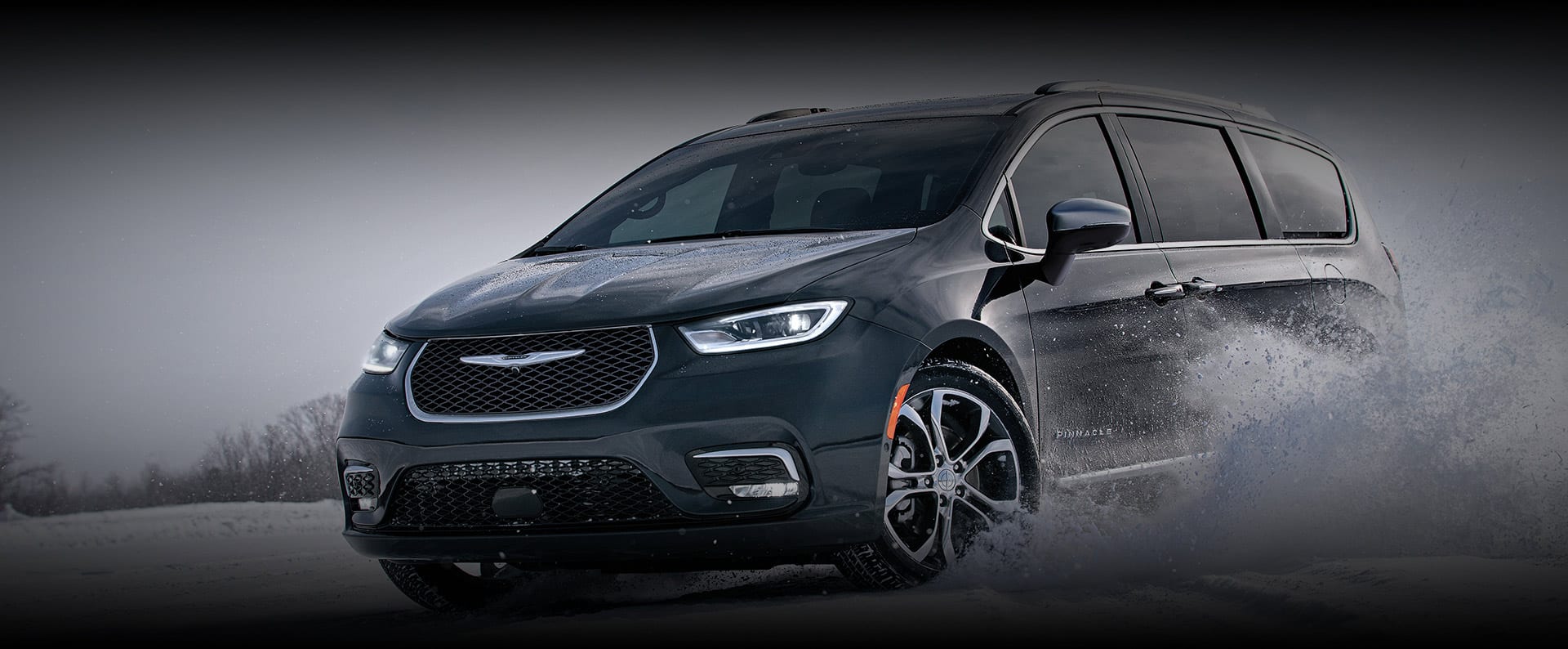 The 2024 Chrysler Pacifica Pinnacle being driven on a snow-covered surface.