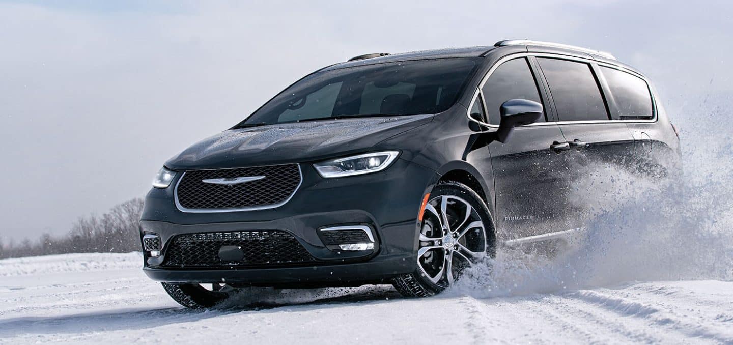 Display The 2024 Chrysler Pacifica Pinnacle being driven on a snow-covered surface.