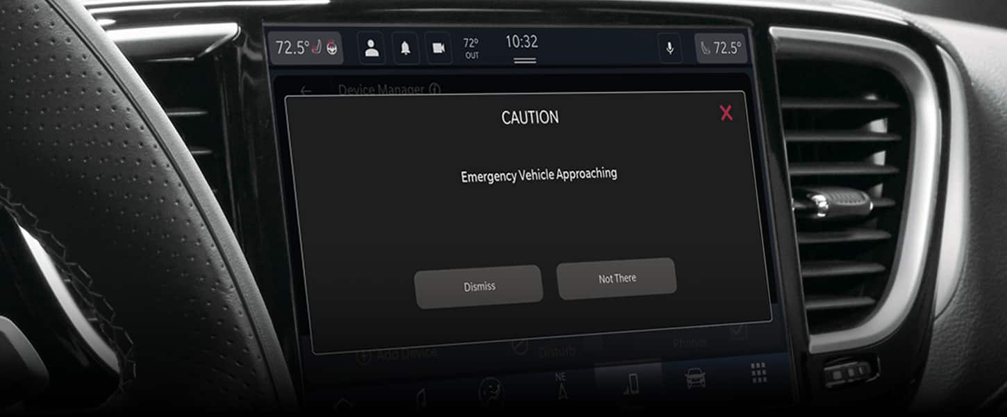 The Uconnect touchscreen in the 2024 Chrysler Pacifica displaying the emergency vehicle approaching alert.