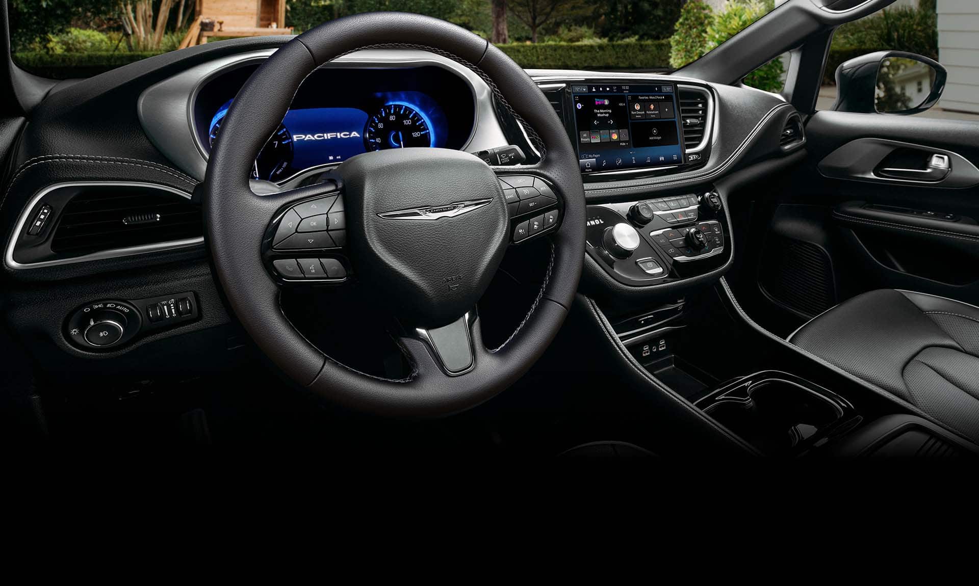 The steering wheel, Digital Cluster Display and Uconnect touchscreen in the 2025 Chrysler Pacifica Plug-in Hybrid.