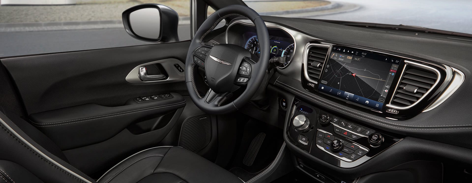 The steering wheel and Uconnect touchscreen in the 2025 Chrysler Pacifica Plug-in Hybrid.