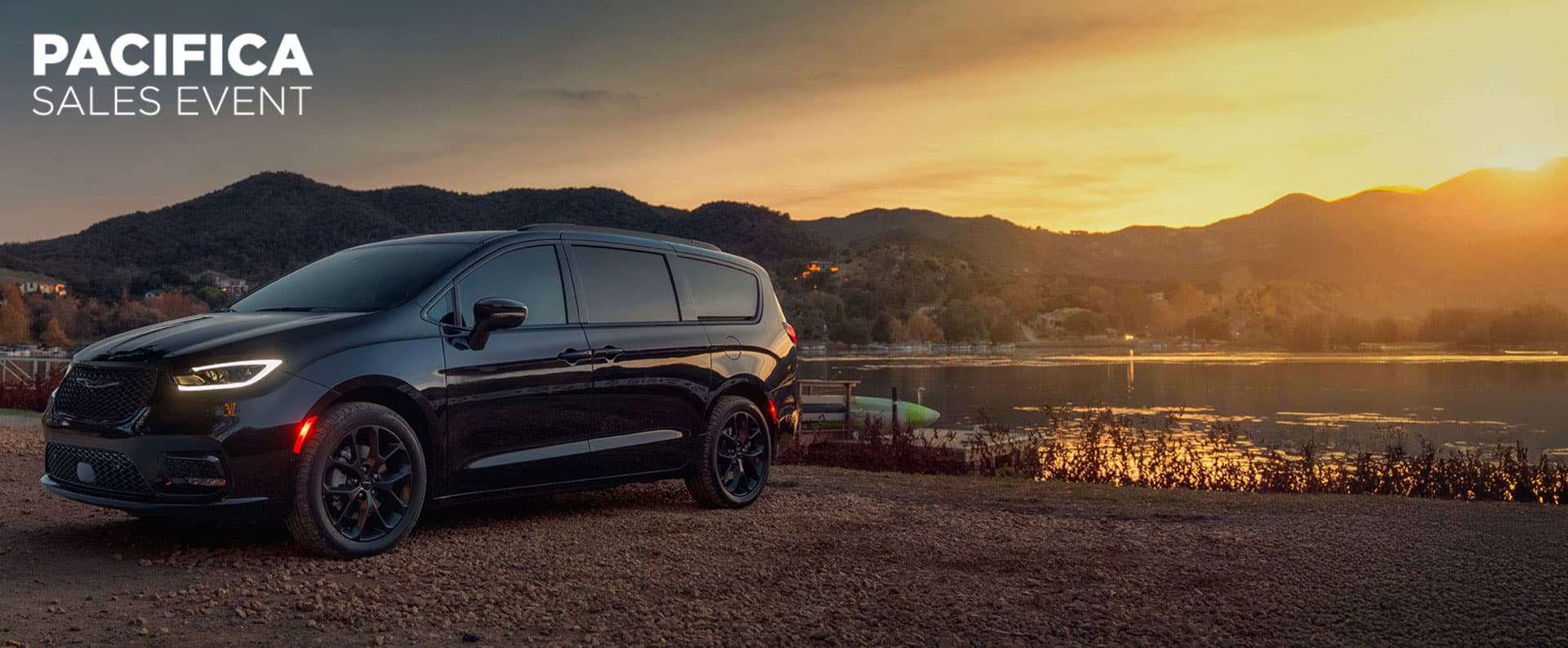 A black 2025 Chrysler Pacifica Limited parked by a lake at sunset. Employee Pricing Plus sales event. Chrysler Pacifica sales event.