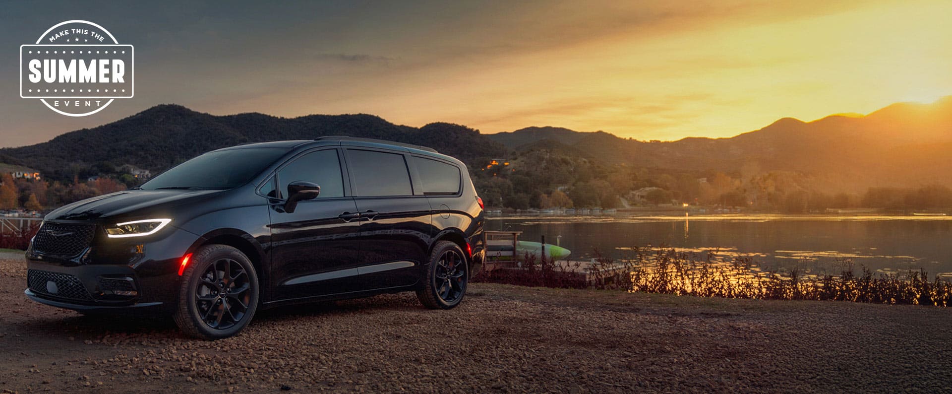 A black 2025 Chrysler Pacifica Limited parked by a lake at sunset. Employee Pricing Plus sales event. Make this the Summer sales event.
