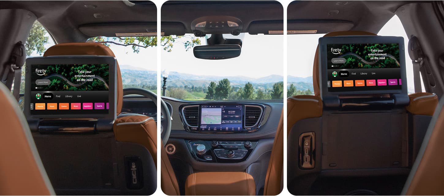 The interior of the 2026 Chrysler Pacifica Plug-in Hybrid Pinnacle shot from the third row forward, with the two seatback-mounted touchscreens in the second row displaying Amazon FireTV selections.