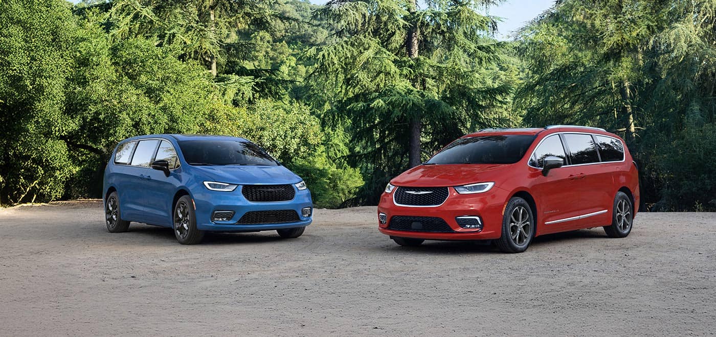 Blue and red Chrysler Pacifica minivans parked side by side