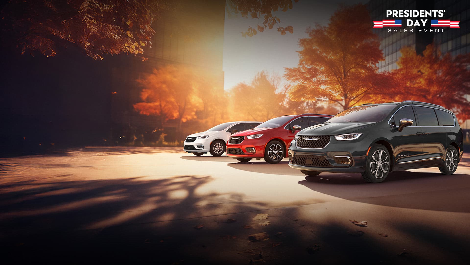 Three 2026 Chrysler minivan models parked on an oceanside beach. From left to right: a white Chrysler Voyager, a blue Pacifica Pinnacle Plug-in Hybrid and a red Pacifica Pinnacle. Presidents' Day Sales Event.