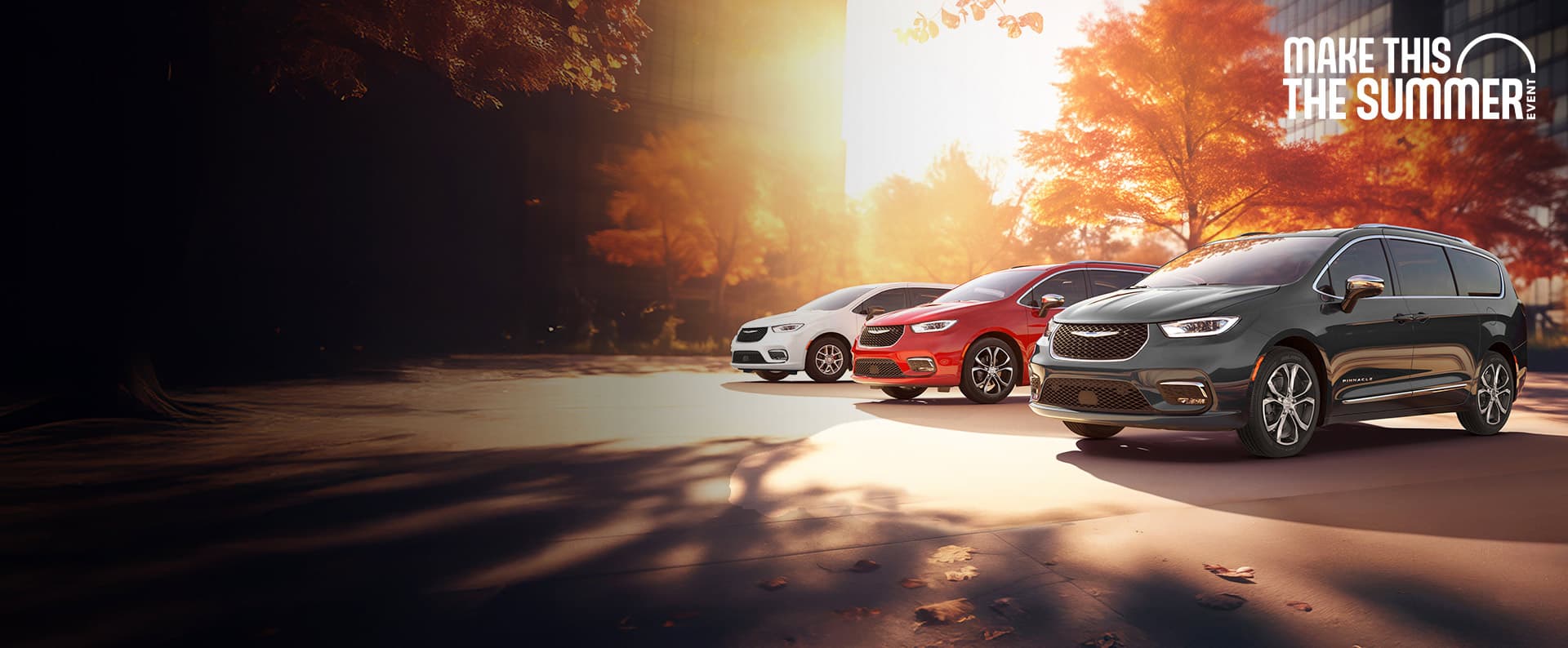 Three 2026 Chrysler minivan models parked on an oceanside beach. From left to right: a white Chrysler Voyager, a blue Pacifica Pinnacle Plug-in Hybrid and a red Pacifica Pinnacle. Make this the Summer Sales Event.