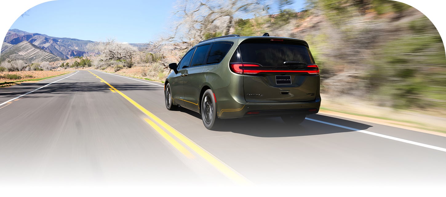 The rear of an olive green 2027 Chrysler Pacifica Limited with the S Appearance Package, traveling down a highway.