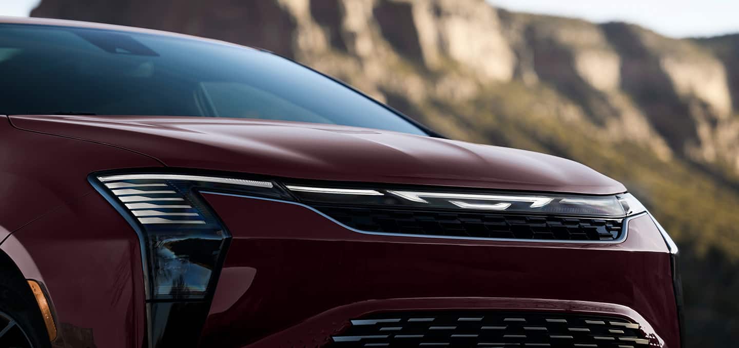 The front end of a red 2027 Chrysler Pacifica Pinnacle.