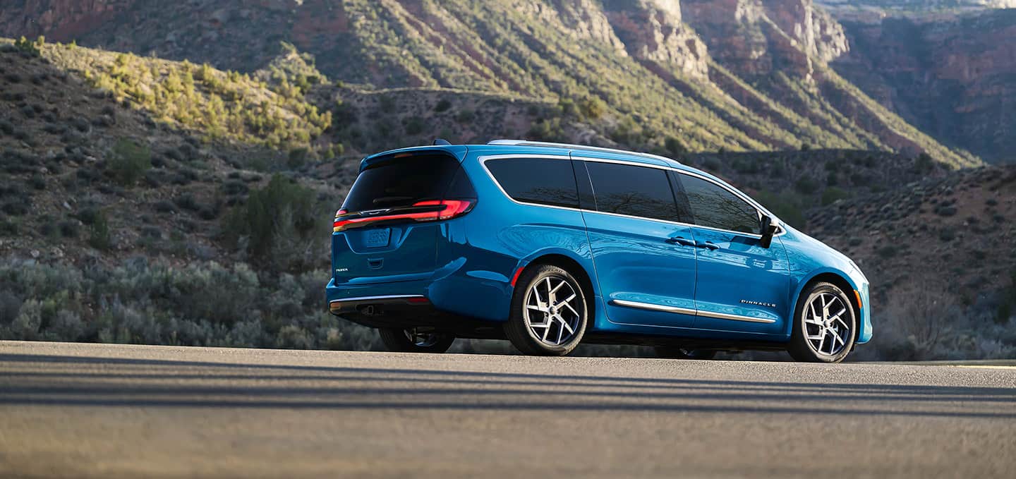 A rear view of a blue Pacifica Pinnacle in a parking lot.