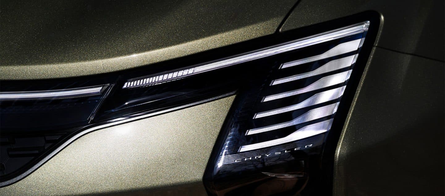 Display The front end of a olive green 2027 Chrysler Pacifica Pinnacle.