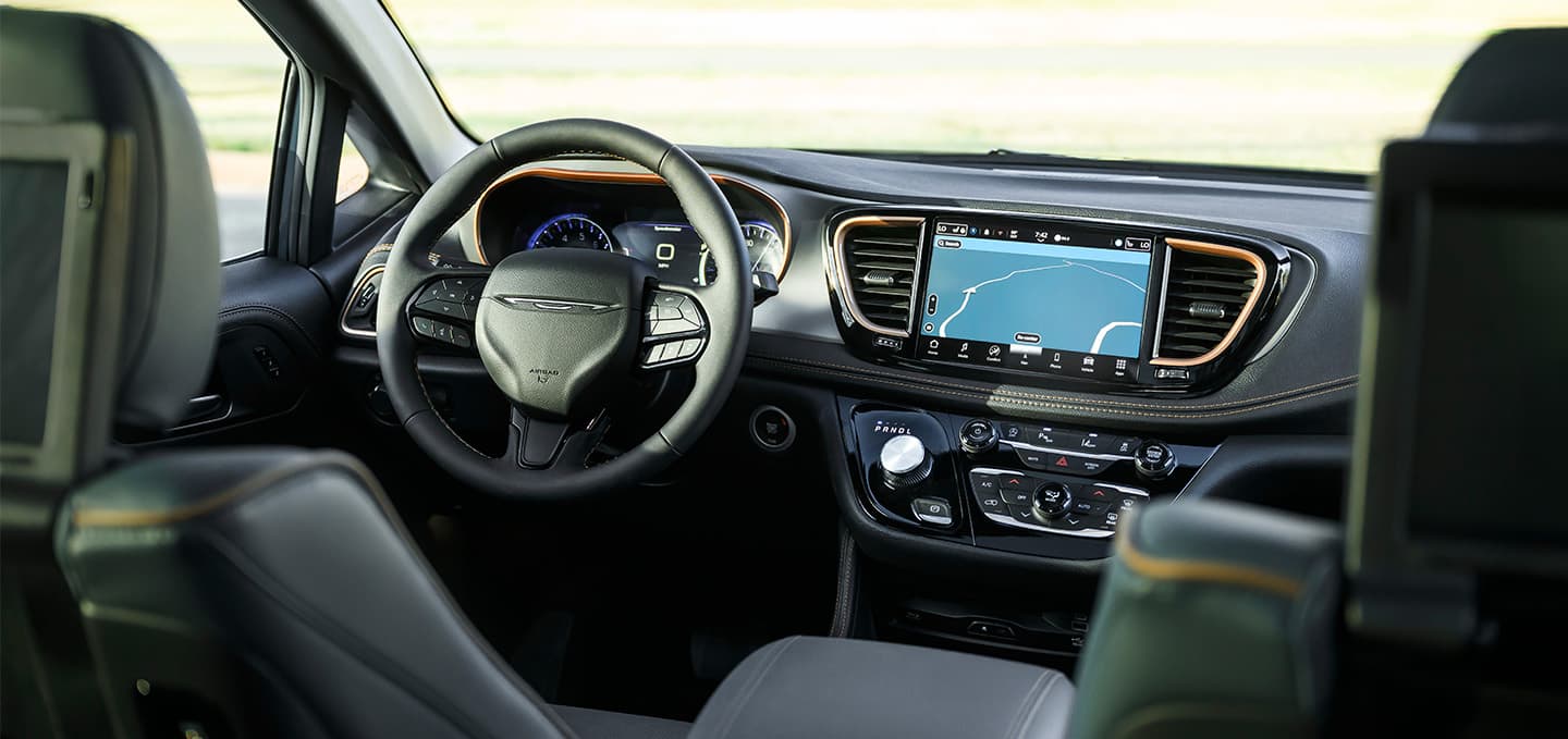 The instrumentation in the 2027 Chrysler Pacifica, including the steering wheel, Digital Cluster Display, Uconnect touchscreen and center stack controls.