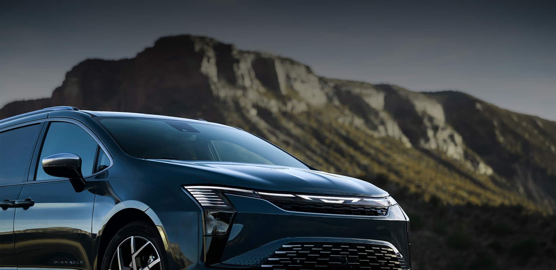 The front end of a blue 2027 Chrysler Pacifica Pinnacle.