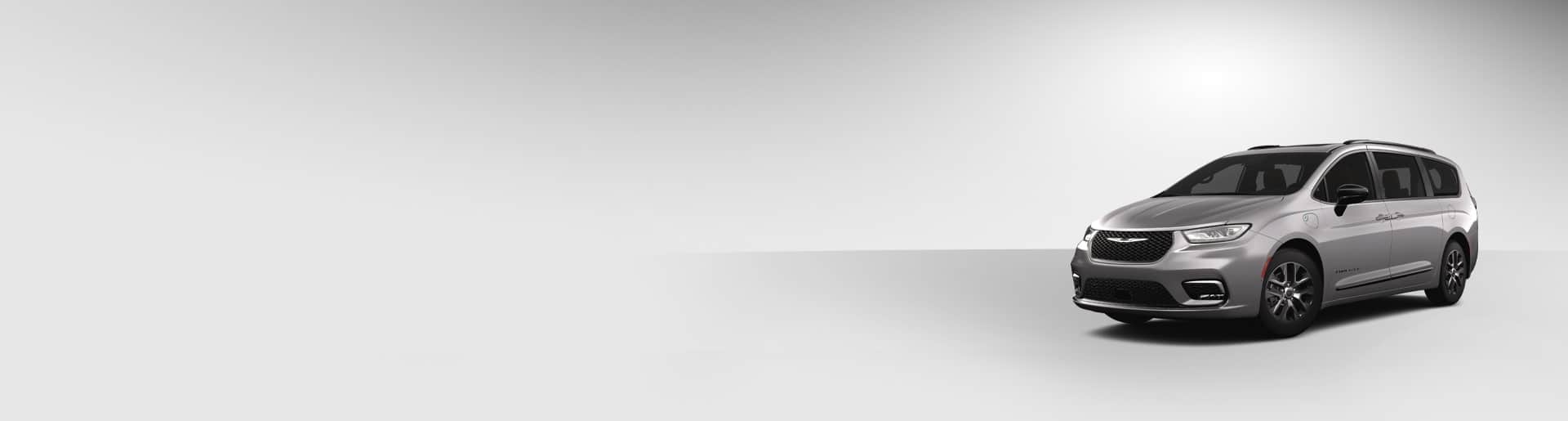 A front driver-side angle of a gray 2024 Chrysler Pacifica Hybrid Pinnacle model.