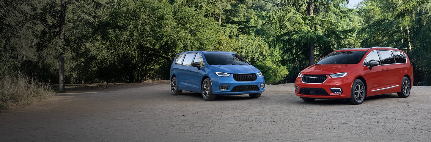 A blue 2026 Chrysler Pacifica Limited with the S Appearance Package and a red 2026 Chrysler Pacifica Pinnacle parked perpendicular to each other.