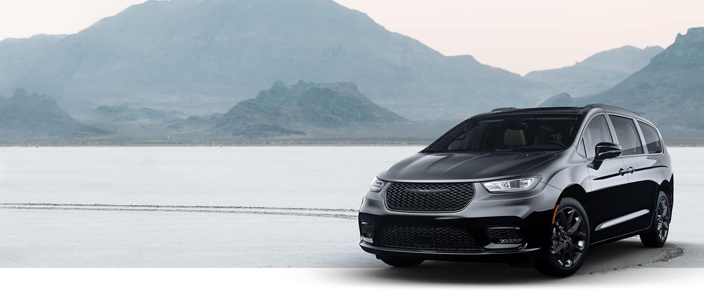 The 2022 Chrysler Pacifica Limited with the S Appearance Package parked on the snow, with fog-covered mountains in the background.