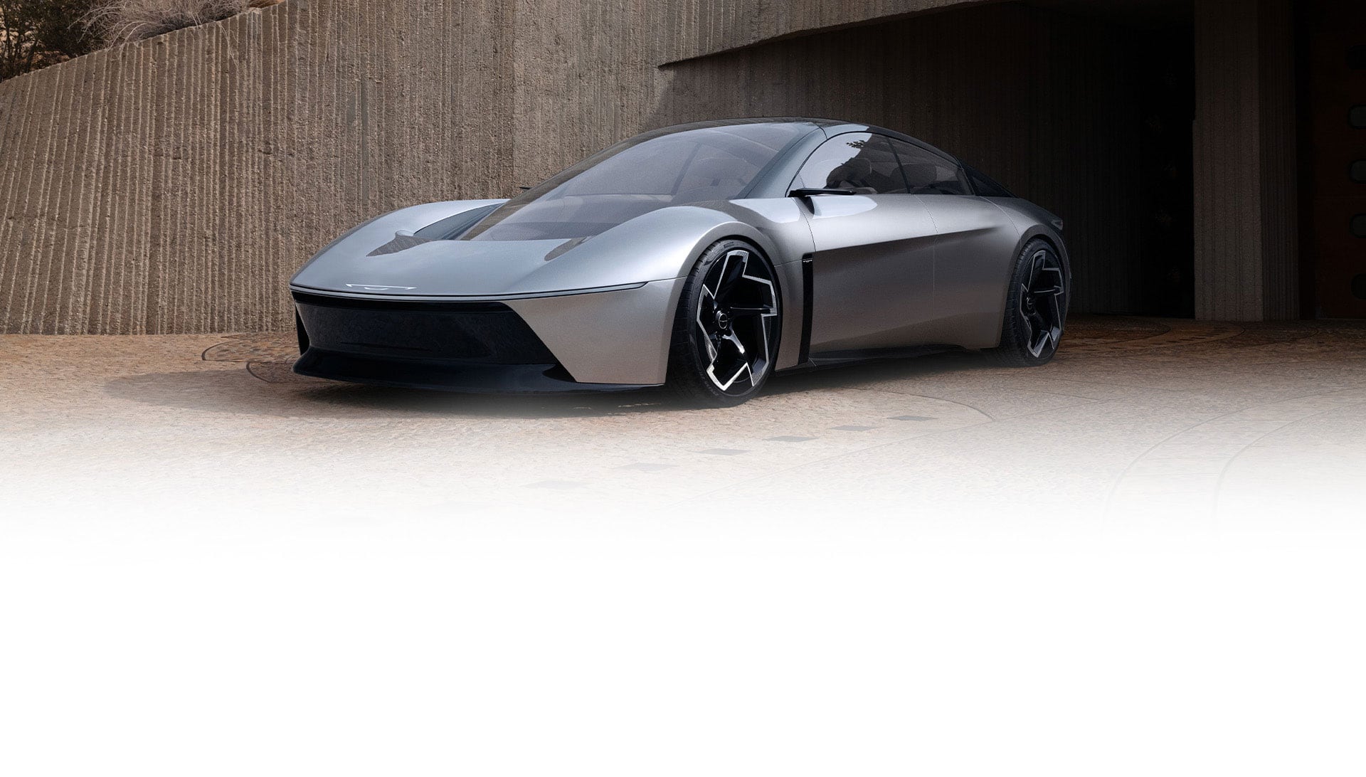 A front driver-side angle of the silver Chrysler Halcyon Concept vehicle parked outside a tunnel.