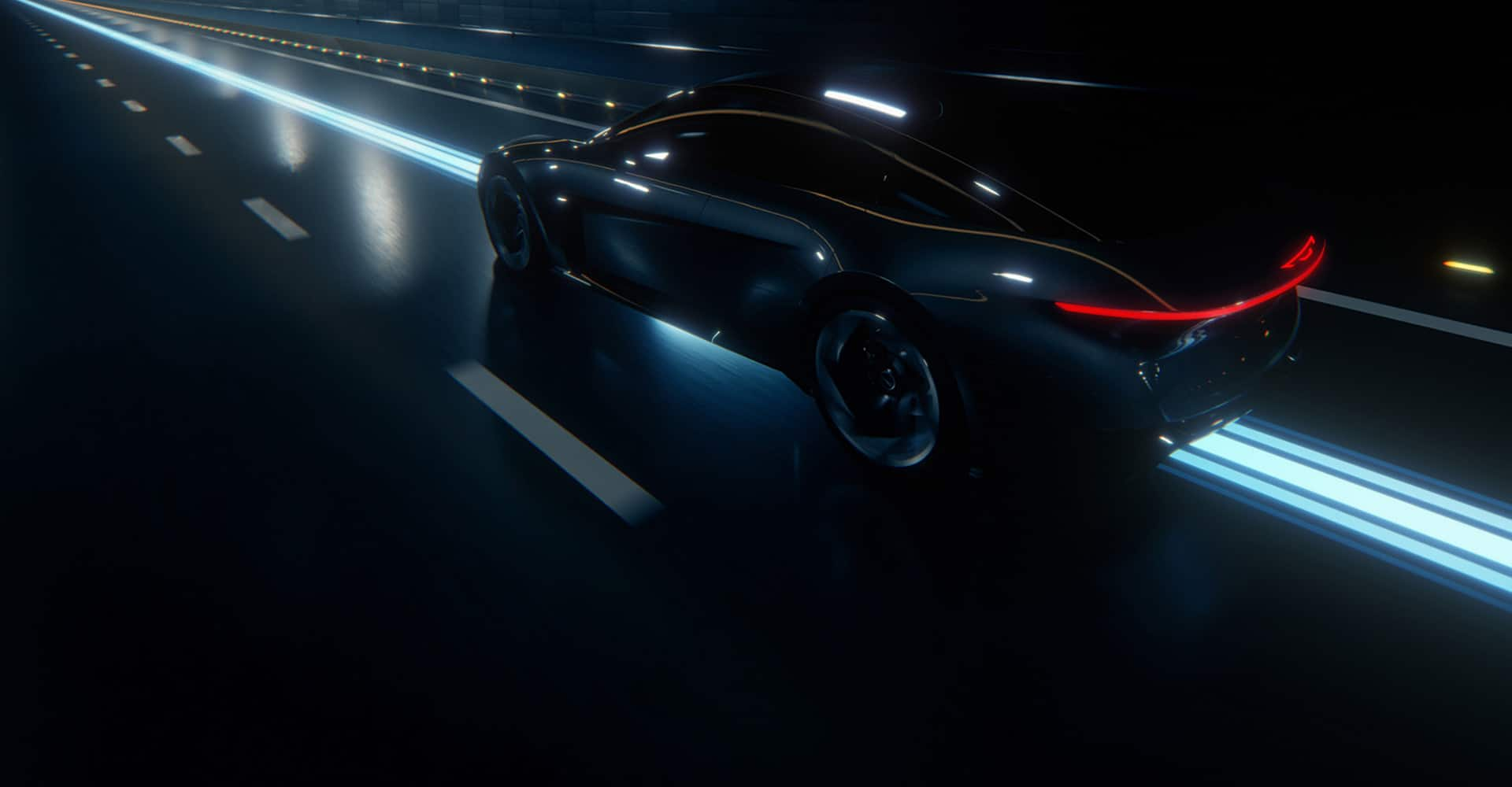 A driver-side rear profile of blue Chrysler Halcyon Concept being driven on a lighted highway at night.