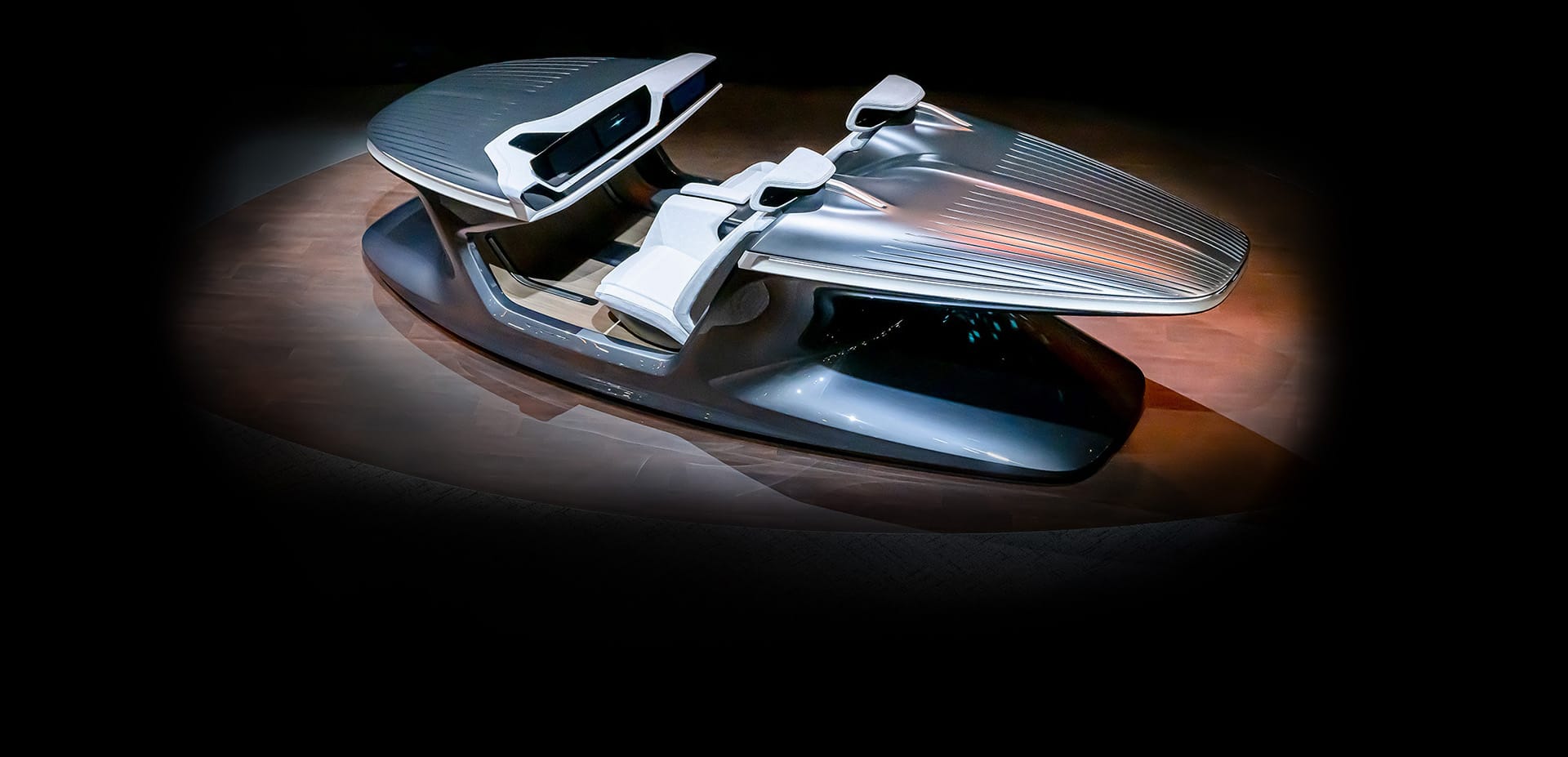 A raised wide angle of the Chrysler Synthesis Concept from the driver side in a dark studio with a spotlight on the vehicle.