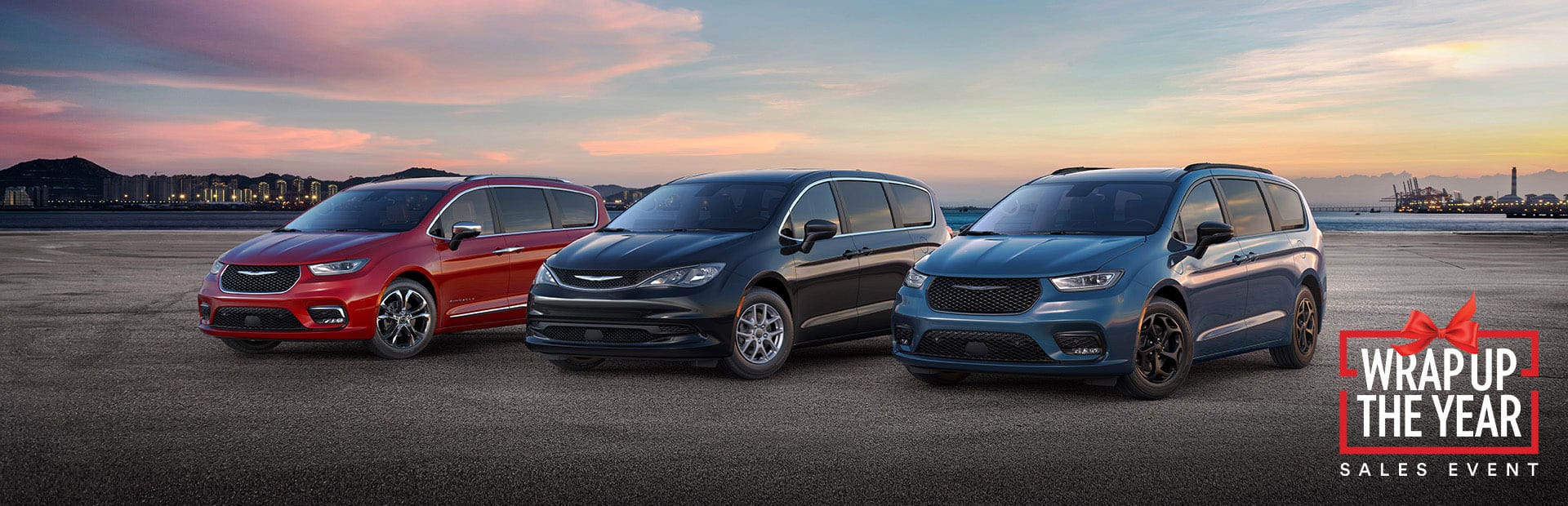 The 2025 Chrysler Brand minivan lineup: from left to right, a red Chrysler Pacifica Pinnacle, a black Chrysler Voyager LX and a blue Chrysler Pacifica Hybrid Select with the Premium S Appearance Package. Wrap Up the Year Sales Event.
