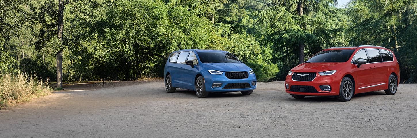 A blue 2026 Chrysler Pacifica Limited with the S Appearance Package and a red 2026 Chrysler Pacifica Pinnacle parked perpendicular to each other.